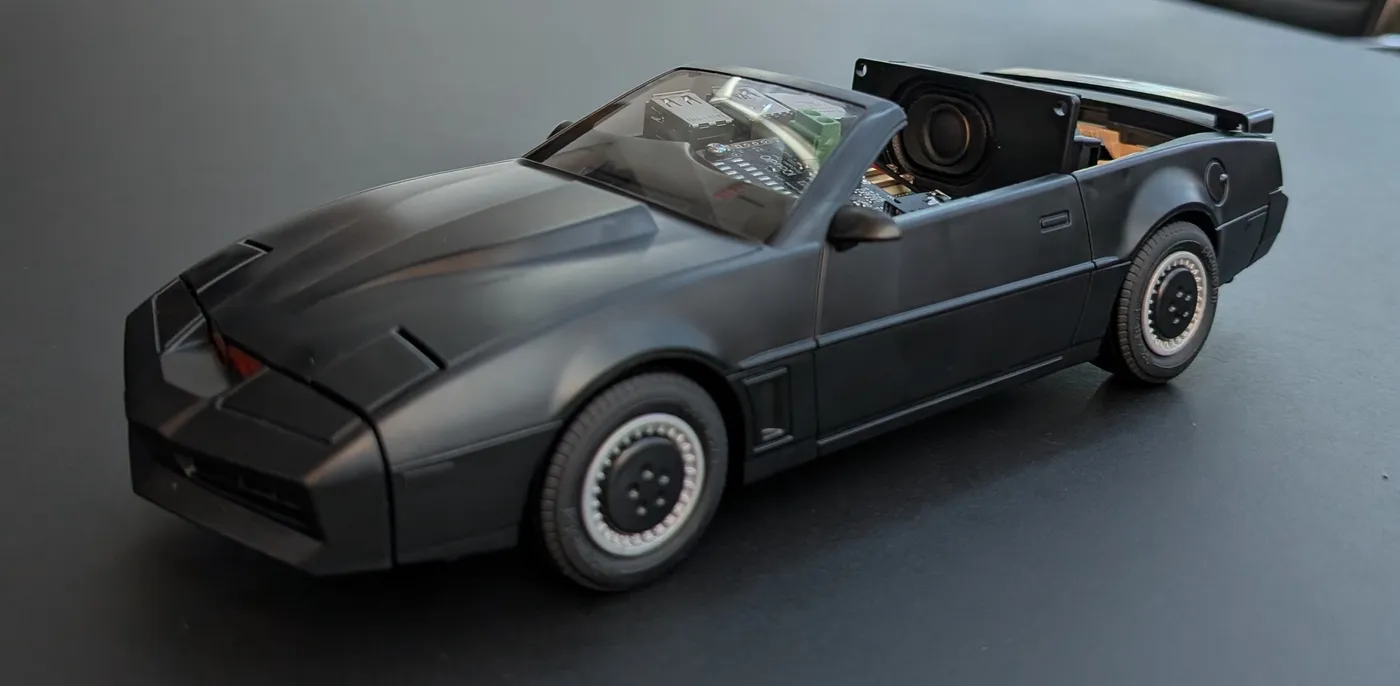The K.I.T.T. toy car with its roof removed, showing a small speaker and electronics inside